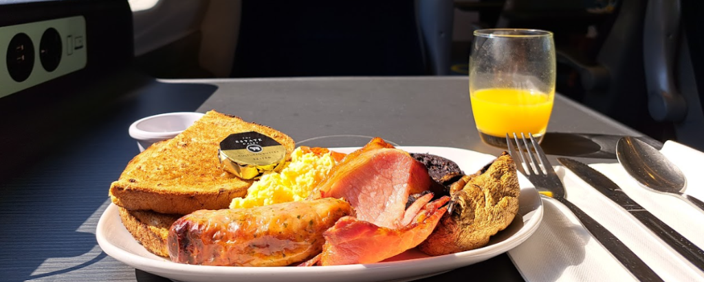 avanti first class breakfast, showing toast, sausage, scrambled egg, bacon, mushroom and black pudding