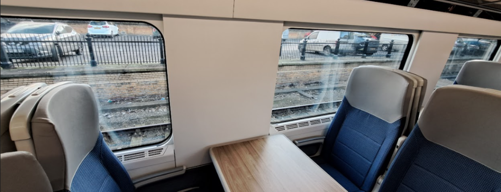 a table seat on tpe trains with an obscured window view